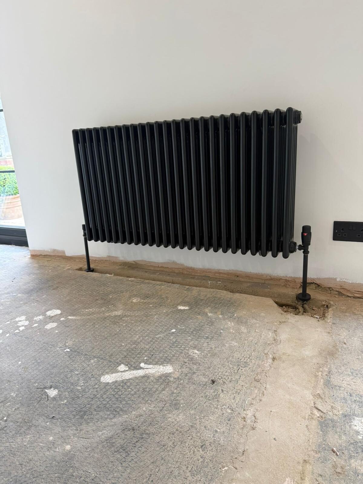 Anthracite triple-column radiator installed during a central heating upgrade in Bedfordshire